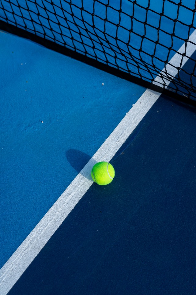 Floodlit padel players trading volleys