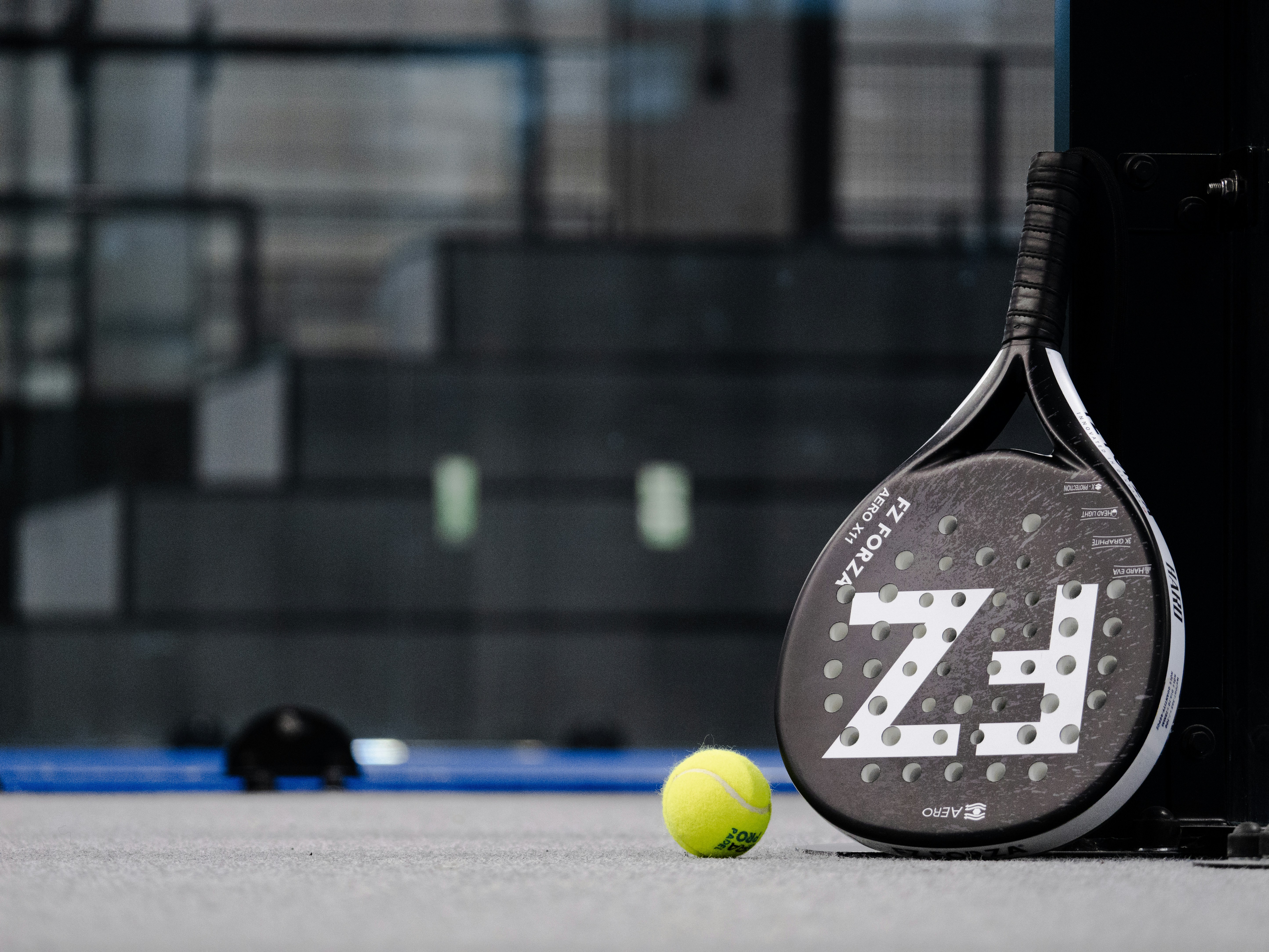 Padel team celebrating beside the court