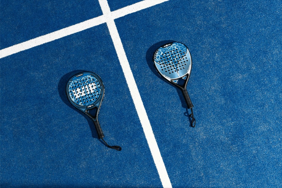 Indoor pickleball players trading volleys